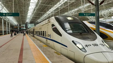 A CRH high-speed train stopped at a station platform in China